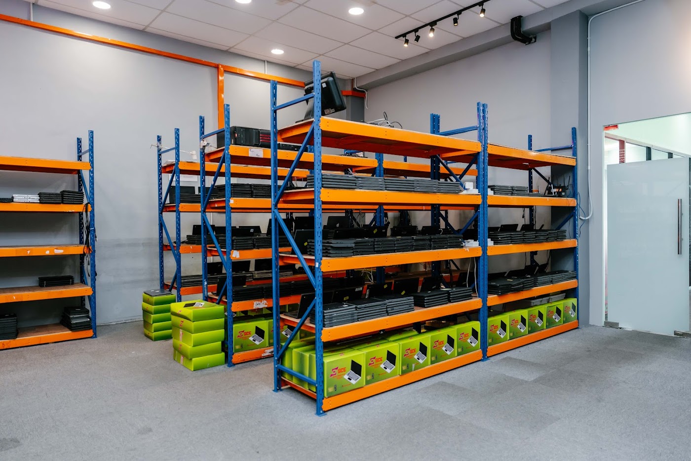 SCE warehouse racks of refurbished laptops